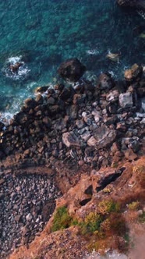 See the Rugged Rocky Shoreline From Above Where Waves Meet Ocean