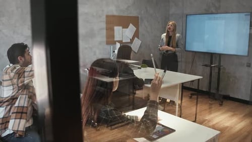 Woman Giving Presentation to Colleagues in Modern Office