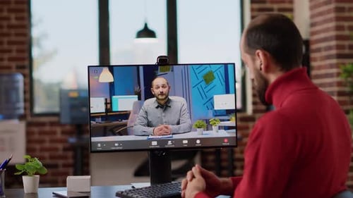 Man on Video Call with Colleague in Office