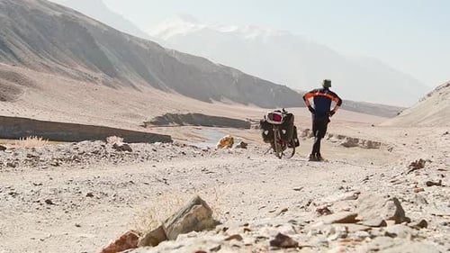 Traveler Stand By Bicycle On Pamir Highway Road (Slow Motion)