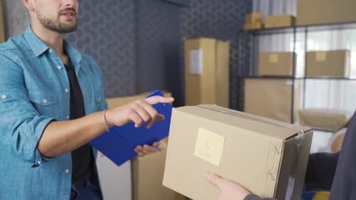 Online store employee shipping orders at dropshipping delivery service warehouse.