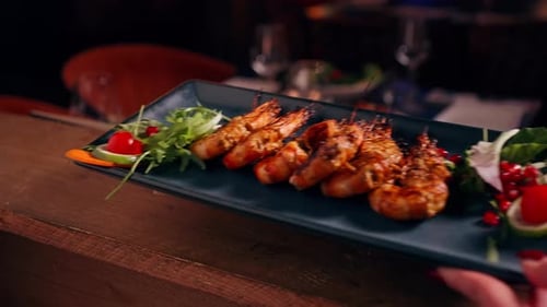 Grilled Shrimp Platter Garnished with Greens at Restaurant