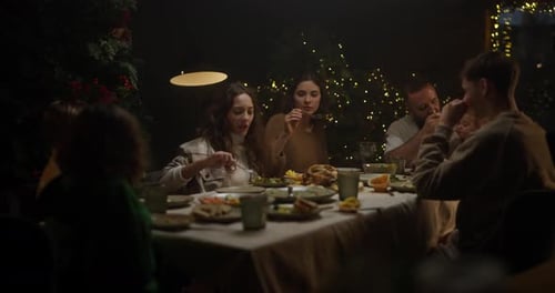 Family enjoys festive holiday dinner together at night