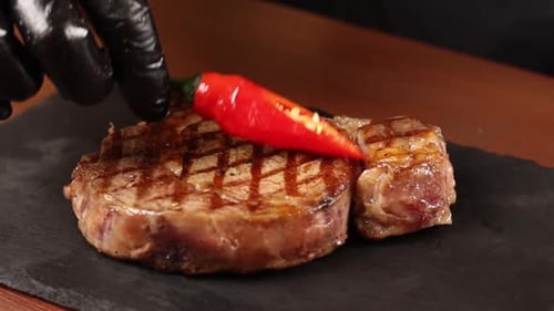 Chef cooks meat on the grill