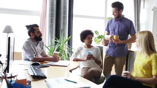 Happy Creative Team Drinking Coffee at Break and Having Discussion in Office African