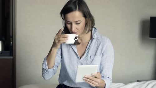 Attractive Businesswoman with Tablet Computer During Breakfast in Hotel Room 30s
