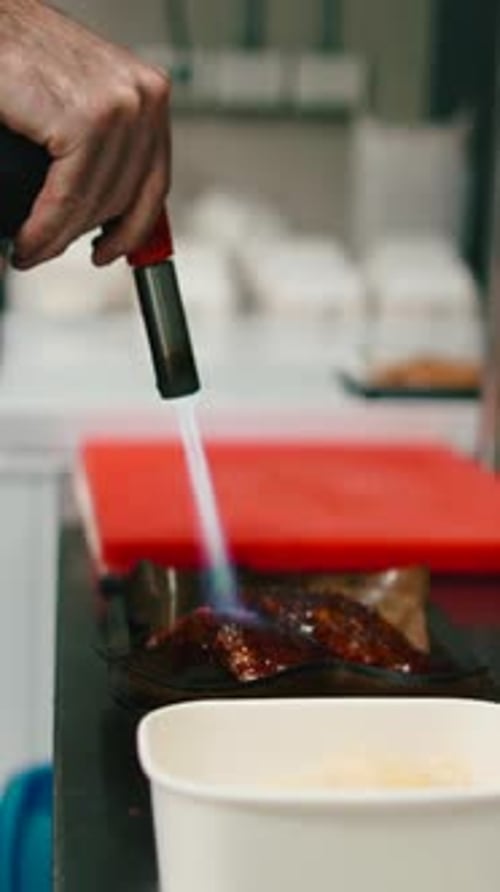 Chef Preparing Food with Blowtorch in Restaurant Kitchen