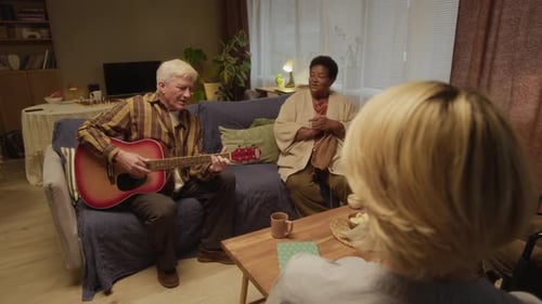 Multiethnic Nursing Home Community Enjoying Relaxing Guitar Music Together