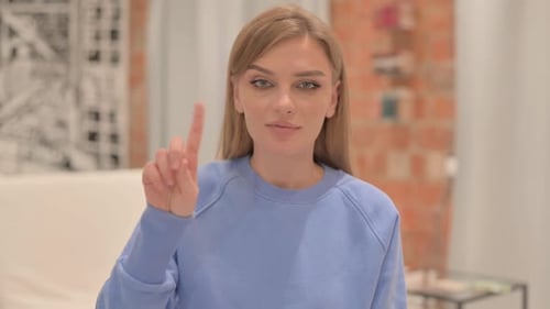 Young Woman Saying No with Finger Gesture