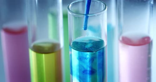 Colorful Liquids Dropped into Test Tube in Laboratory