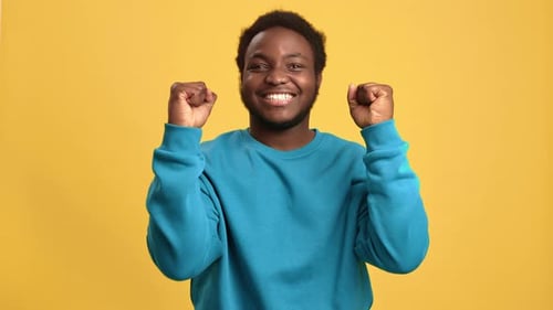 Portrait Overjoyed African Man Rejoice Good News Celebrate Win Posing Isolated on Orange Studio