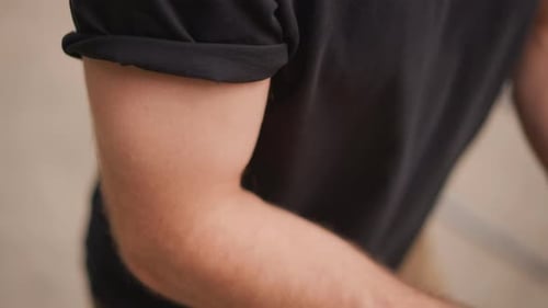 Closeup Of Arm Securing Elastic Athlete Preparing Elastic Band For Workout Man Handling Elastic Band