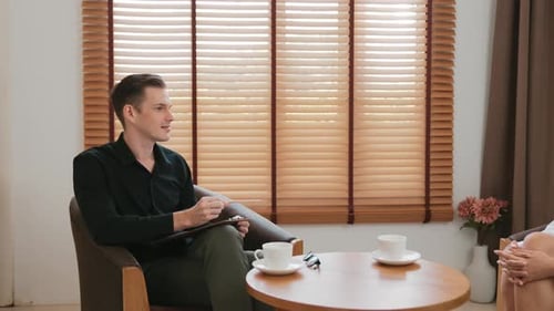 Consultation with a Therapist: Man and Woman Talking Indoors