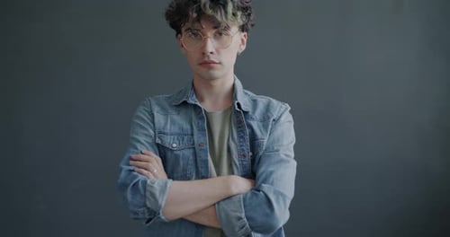 Serious Young Adult Posing with Arms Crossed