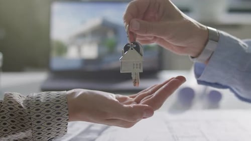 Property Buyer Receiving Keys from Seller during Real Estate Handover