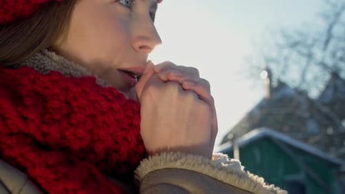 Close Up Face Cute Woman Dressed Knitted Accessories Trying Warm Her Hands Blowing Arms with Hot