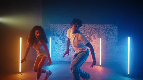 Hiphop Dance Style with Ethnic Elements Man and Woman Dancing Together in Hall Attractive African