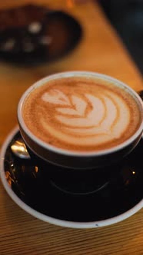 Latte art coffee in a black cup