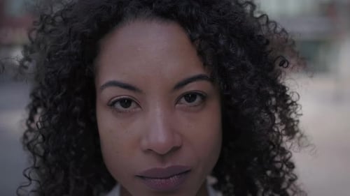 Close Up Face Serious Middleaged African American Woman Looking Earnest at Camera Afro Hair