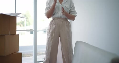 Woman Relaxes After Moving Furniture to New Home