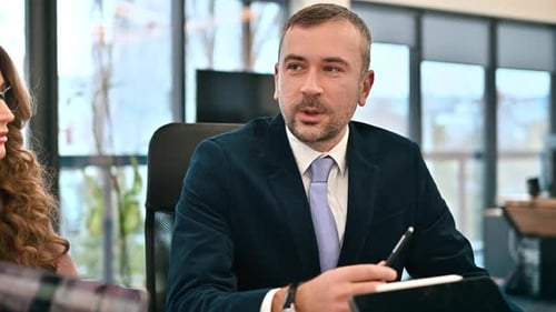 Team leader leading a business meeting in an office, workers discussing business affairs. Gadgets on