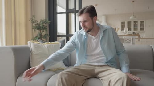 Young Adult Man Playing Video Games at Home