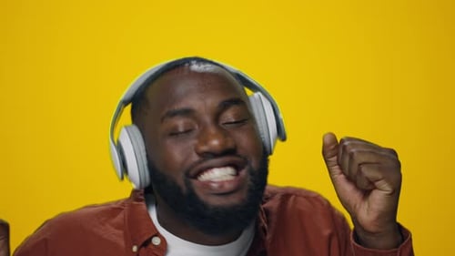 Enthusiastic man listening to music and dancing