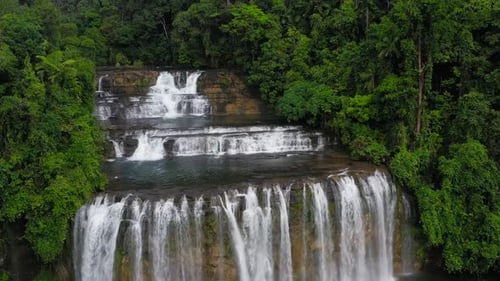 Majestic Waterfall Cascading Through Lush Tropical Rainforest