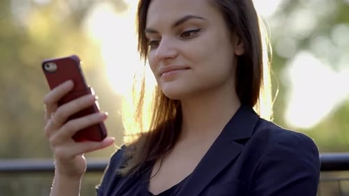 Young Beautiful Caucasian Woman Using Smart Phone in the City