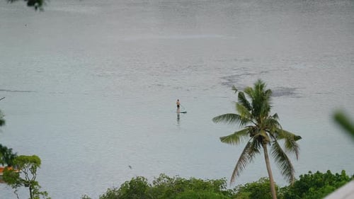 Man Chilling And Stand-Up Paddleboarding During Sunset At Moso Island In Vanuatu. - wide