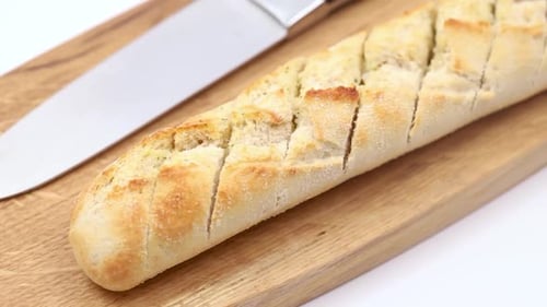 Freshly Baked Bread on Cutting Board with Knife