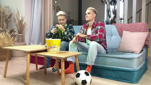 Friends Watching TV with Popcorn and Beer