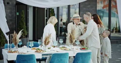 Family Joins Wedding Reception Outdoors on Sunny Day
