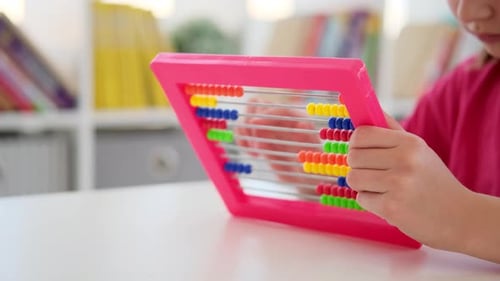 Child Using Colorful Abacus for Math Learning