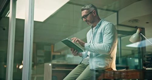 Man Uses Tablet in Modern Workplace Office