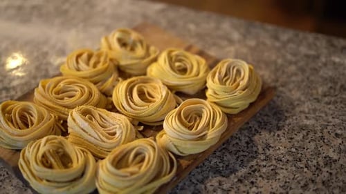 Spaghetti Rolls on Cutting Board in Restaurant