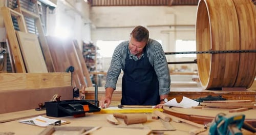 Mature man, carpenter and drawing at workshop for furniture and design