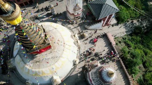 Aerial view over Swayambhunath temple pagoda roof, ancient buddhist monastery, with prayer flags, Ka