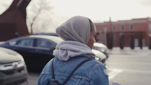 Junge Frau im Hijab überquert die Urban Street 25-29 Jahre