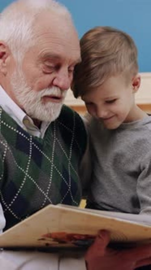 Grandfather Reading Book with Grandson