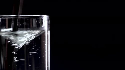 Liquid Poured into Glass Creating Abstract Swirl
