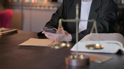 Close Up of Judge using Smartphone in Court