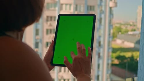 Woman Using Tablet With Chroma Key Green Screen