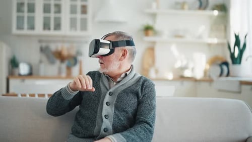 Senior Man Wearing VR Headset at Home
