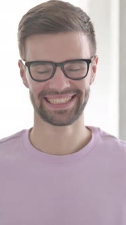 Man Wearing Glasses Smiles in Portrait Orientation Video