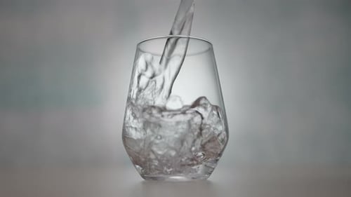 Water Pouring into Glass with Bubbles
