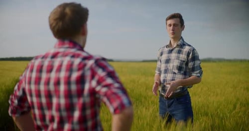 Two Male Farmers Discussing In Field Agriculture Crops Business Talking