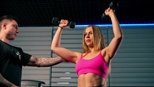 Close Up Vertical Video in the Gym Pair Training of a Guy Trainer and a Girl the Guy Controls the