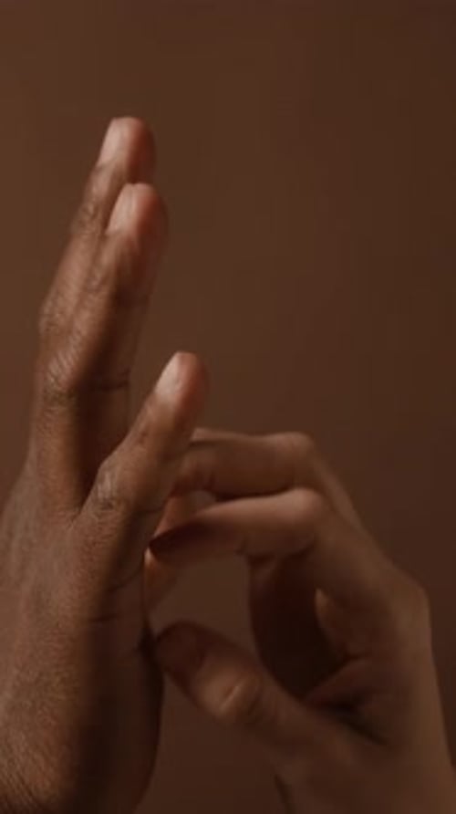 Close Up of Light and Dark Skin Hands Together