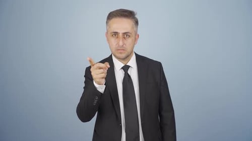 Businessman alerting camera with stern expression.